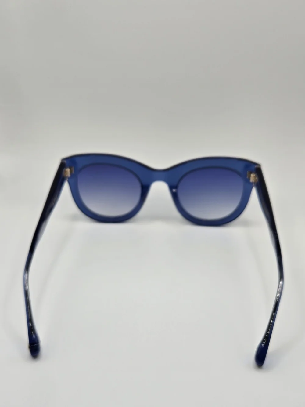 Aperçu sunglasses featuring a bold acetate frame and gold tone branding
